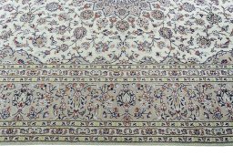 Corner detail of 2000s Kashan rug showing border pattern and Wool pile