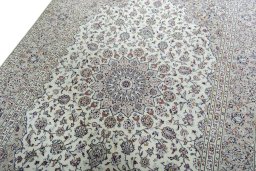 Backside of handmade 2000s Kashan rug showing knot structure and weave density