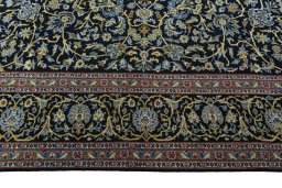 Corner detail of 2000s Kashan rug showing border pattern and Wool pile