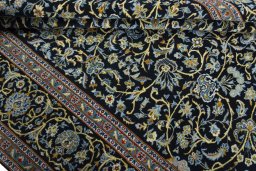 Close-up detail of 2000s Kashan rug from Iran / Persia showing Wool weave