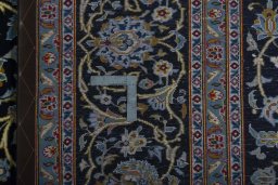 Backside of handmade 2000s Kashan rug showing knot structure and weave density