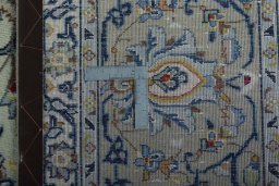 Backside of handmade 1970s Kashan rug showing knot structure and weave density