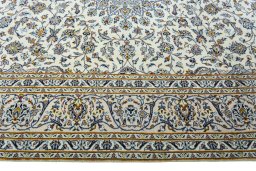 Corner detail of 2000s Kashan rug showing border pattern and Wool pile