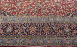 Corner detail of 2000s Kashan rug showing border pattern and Cork pile