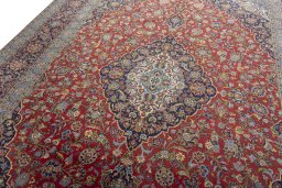Backside of handmade 2000s Kashan rug showing knot structure and weave density
