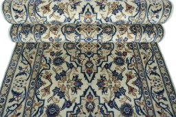 Corner detail of 2000s Kashan rug showing border pattern and Wool pile