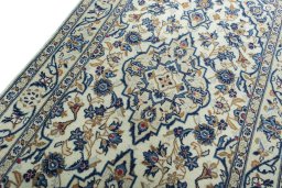 Backside of handmade 2000s Kashan rug showing knot structure and weave density