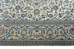 Corner detail of 2000s Kashan rug showing border pattern and Wool pile
