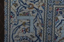 Backside of handmade 2000s Kashan rug showing knot structure and weave density