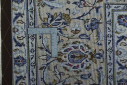 Backside of handmade 2000s Kashan rug showing knot structure and weave density