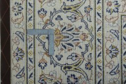 Backside of handmade 2000s Kashan rug showing knot structure and weave density