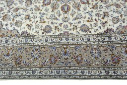 Corner detail of 2000s Kashan rug showing border pattern and Wool pile