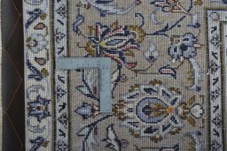 Backside of handmade 2000s Kashan rug showing knot structure and weave density