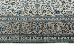 Corner detail of 2000s Kashan rug showing border pattern and Wool pile