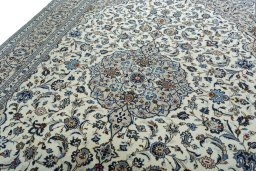 Backside of handmade 2000s Kashan rug showing knot structure and weave density