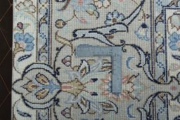 Backside of handmade New Kashan rug showing knot structure and weave density