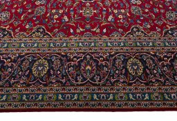 Corner detail of 2000s Kashan rug showing border pattern and Wool pile