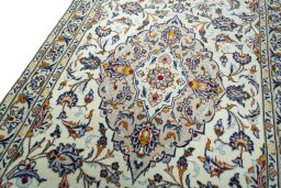 Backside of handmade 2000s Kashan rug showing knot structure and weave density