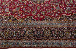 Corner detail of 2000s Kashan rug showing border pattern and Wool pile