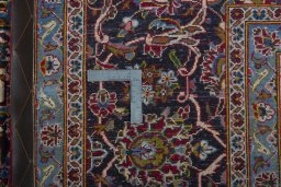 Backside of handmade 2000s Kashan rug showing knot structure and weave density