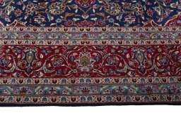 Corner detail of 2000s Kashan rug showing border pattern and Wool pile