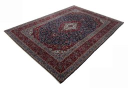 Corner detail of 2000s Kashan rug showing border pattern and Wool pile