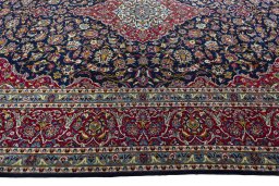 Corner detail of 2000s Kashan rug showing border pattern and Wool pile