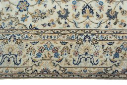 Corner detail of 2000s Kashan rug showing border pattern and Wool pile