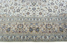Corner detail of 2000s Kashan rug showing border pattern and Wool pile