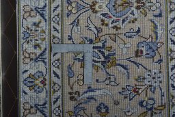 Backside of handmade 2000s Kashan rug showing knot structure and weave density