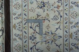 Backside of handmade New Kashan rug showing knot structure and weave density