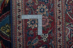 Backside of handmade 1930s Kashan rug showing knot structure and weave density