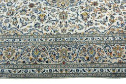 Corner detail of 2000s Kashan rug showing border pattern and Wool pile