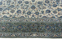 Corner detail of 2000s Kashan rug showing border pattern and Wool pile