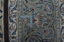 Backside of handmade 2000s Kashan rug showing knot structure and weave density