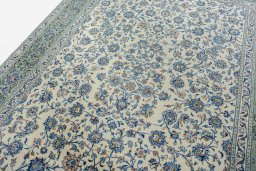 Backside of handmade 2000s Kashan rug showing knot structure and weave density