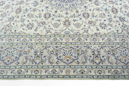 Corner detail of 2000s Kashan rug showing border pattern and Wool pile