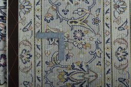 Backside of handmade 2000s Kashan rug showing knot structure and weave density