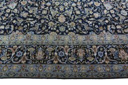 Corner detail of 2000s Kashan rug showing border pattern and Wool pile