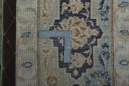 Backside of handmade 2000s Kashan rug showing knot structure and weave density
