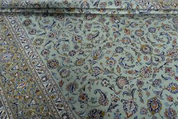 Corner detail of 2000s Kashan rug showing border pattern and Wool pile