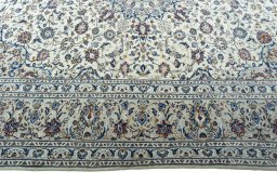 Corner detail of 2000s Kashan rug showing border pattern and Wool pile