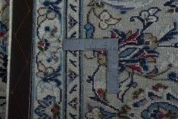 Backside of handmade 2000s Kashan rug showing knot structure and weave density