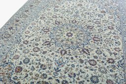 Backside of handmade 2000s Kashan rug showing knot structure and weave density