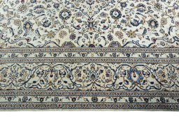 Corner detail of 2000s Kashan rug showing border pattern and Wool pile