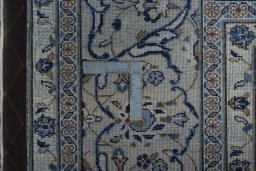 Backside of handmade 2000s Kashan rug showing knot structure and weave density