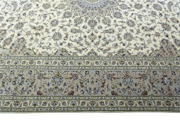 Corner detail of 2000s Kashan rug showing border pattern and Wool pile