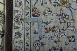 Backside of handmade 2000s Kashan rug showing knot structure and weave density