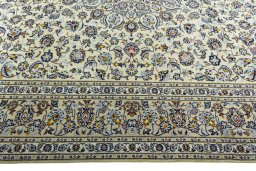 Corner detail of 2000s Kashan rug showing border pattern and Wool pile