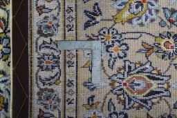 Backside of handmade 2000s Kashan rug showing knot structure and weave density